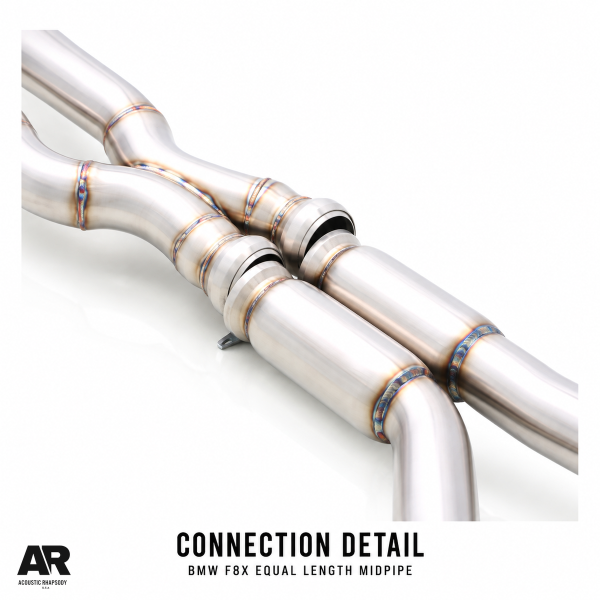 AR BMW F8X equal length midpipe connection detail showing paired couplings and adjacent cylindrical sections.